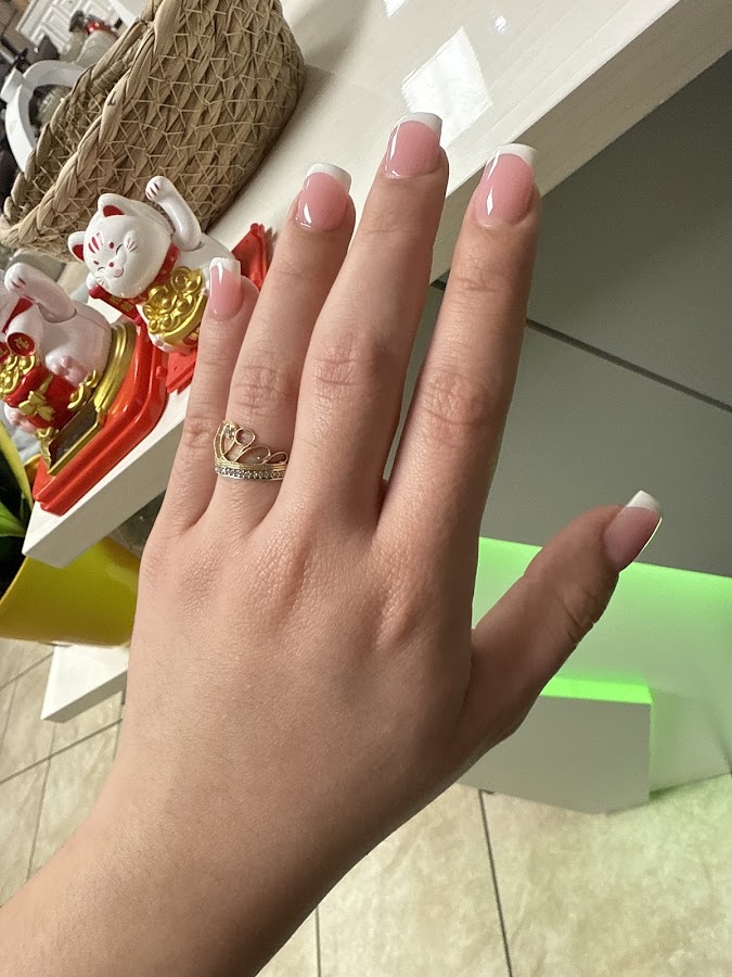 Clean, elegant white French-tip nails in a soft natural shape
